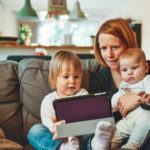 Mom with two kids on a tablet - alexander-dummer-150646